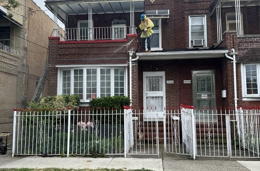 Residential house power washing for exterior surface cleaning.